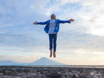 Full length of man standing against sky during sunset