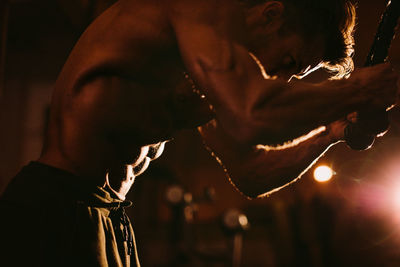 Shirtless man exercising at home