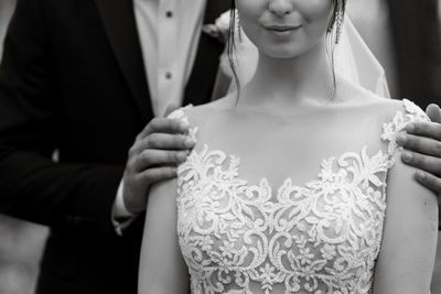 Midsection of bride standing outdoors