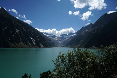 Scenic view of lake and mountains against sky