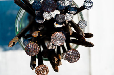 Close-up of nails in jar on table