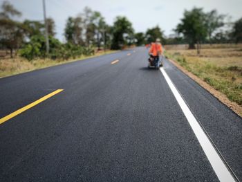 View of person riding motorcycle on road