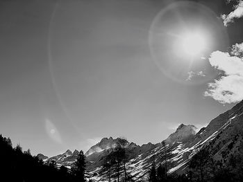 Low angle view of snowcapped mountains against sky