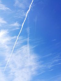 Low angle view of vapor trail in blue sky