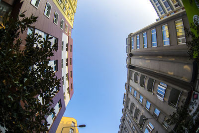 Low angle view of buildings against blue sky