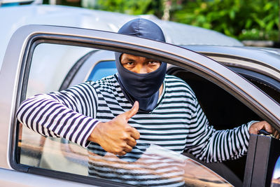 Portrait of man sitting in car