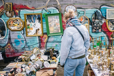 Rear view of woman standing at market stall