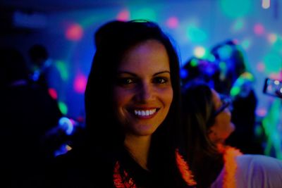 Close-up portrait of smiling beautiful woman during party