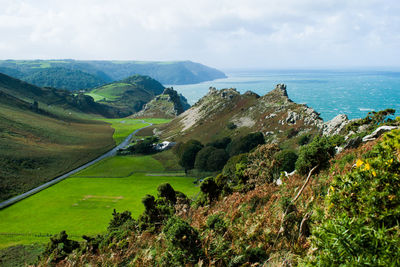 Scenic view of sea and mountains against sky