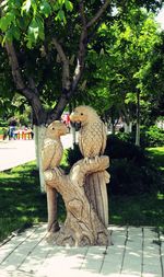 Statue by tree in park