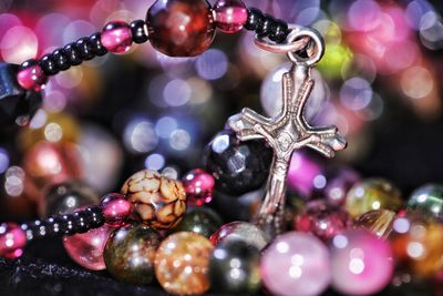 Close-up of cross with bead necklace