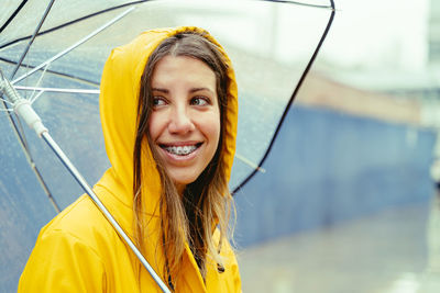 Portrait of young woman with umbrella