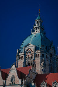 Low angle view of building against clear blue sky