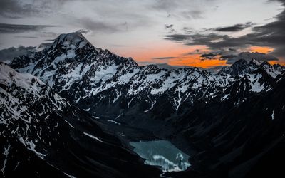 Scenic view of snowcapped mountains against sky during sunset