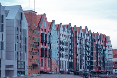 Low angle view of buildings against sky in city