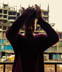 Portrait of man standing in city
