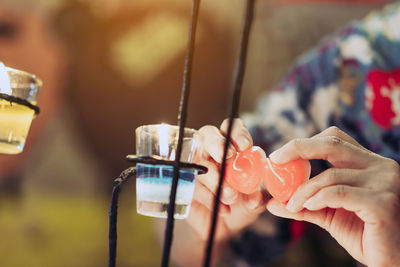 Close-up of woman holding candles