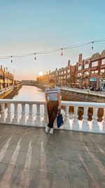 Rear view of woman sitting on street