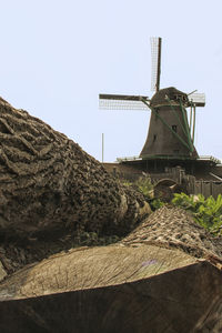 Low angle view of traditional windmill against clear sky