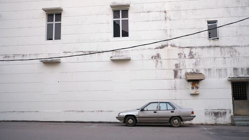 Car parked on street against building