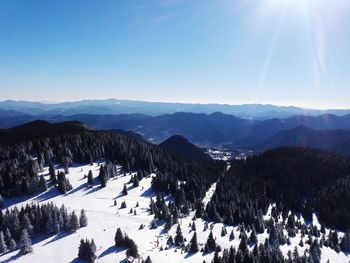 Scenic view of snowcapped mountains against clear sky