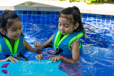 Happy siblings in swimming pool