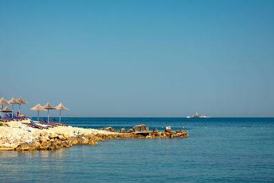 Scenic view of sea against clear blue sky