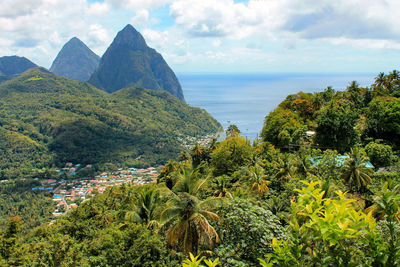 Scenic view of sea and mountains against sky