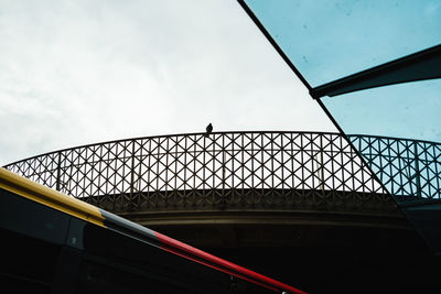 Low angle view of skylight in building against sky