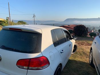 Panoramic shot of road on field against clear sky