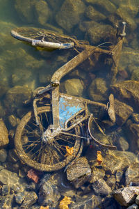 High angle view of abandoned bicycle in sea