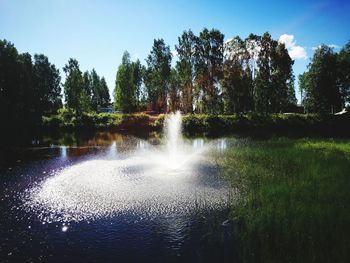 Scenic view of waterfall against sky