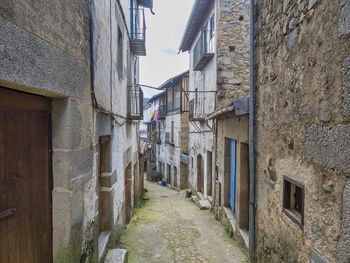 Narrow alley amidst buildings in town