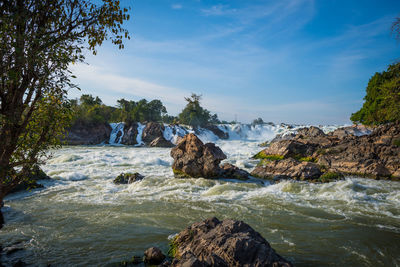 Scenic view of rocks in sea against sky