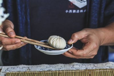 Midsection of man having food