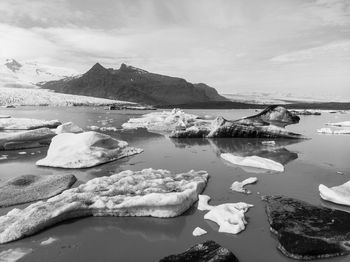 Scenic view of glacier lake against sky and mountain 