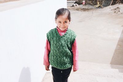 Portrait of smiling girl standing outdoors