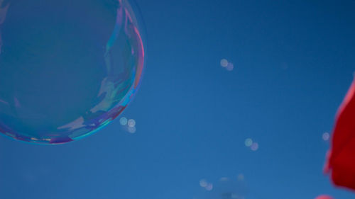 Low angle view of bubbles against clear sky