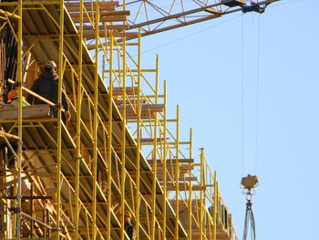 Low angle view of construction site against sky