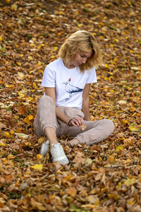 Side view of woman picking leaves