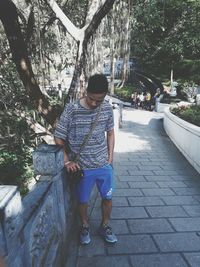 Full length of man standing by tree