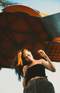 Young woman with arms raised