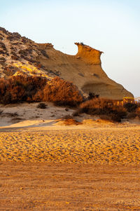 Rock formations on land against sky