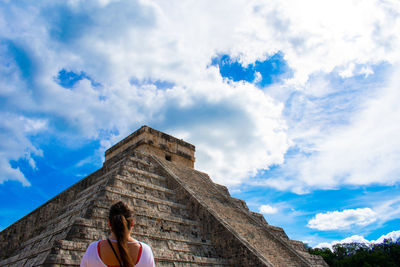 Rear view of woman standing by chichen itza