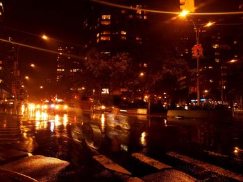 Illuminated city street and buildings at night