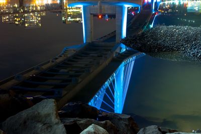 Illuminated bridge over river