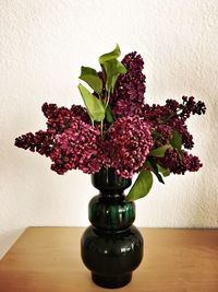 Close-up of flowering plant in vase on table at home