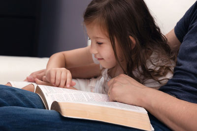 Midsection of woman reading book