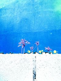 Close-up of wall against blue sky