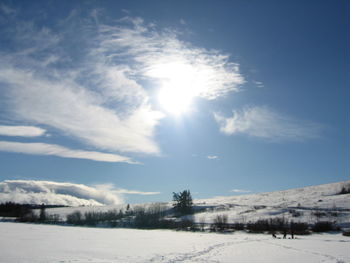 Scenic view of snow covered landscape against sky